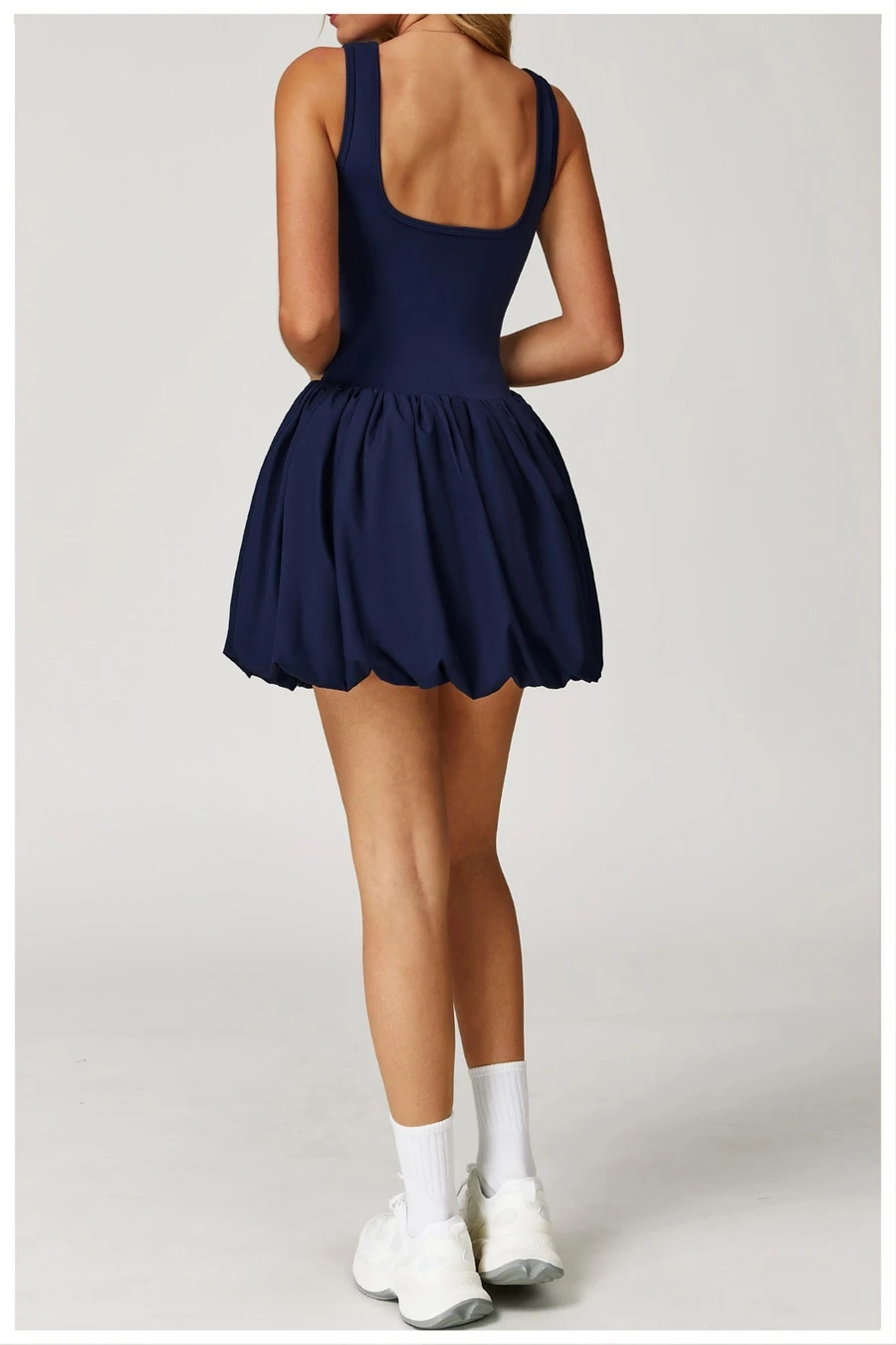 Back view of women's flounce hem running dress showcasing the playful bubble silhouette