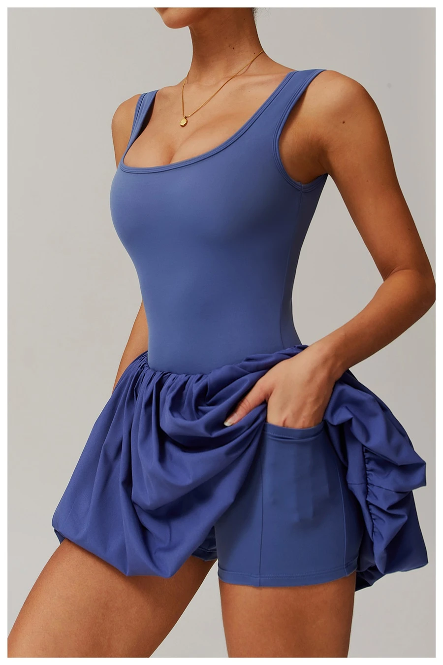 Side view of sports dress highlighting waist-cinching pleated detail and A-line flounce hem