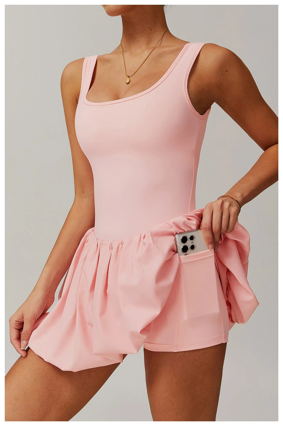 Side view of sports dress highlighting waist-cinching pleated detail and A-line flounce hem