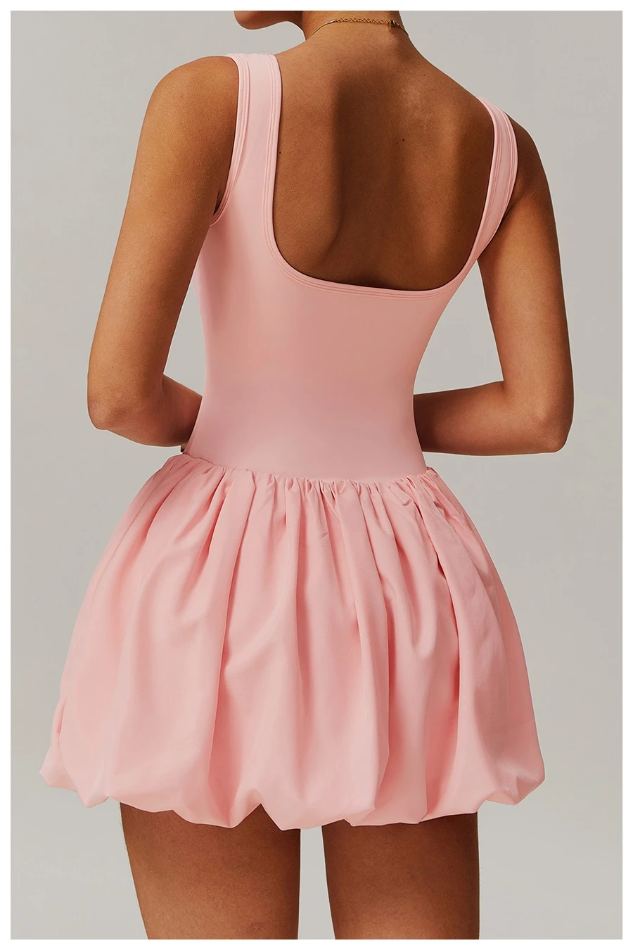 Back view of women's flounce hem running dress showcasing the playful bubble silhouette