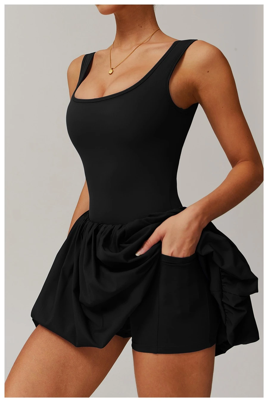 Side view of sports dress highlighting waist-cinching pleated detail and A-line flounce hem