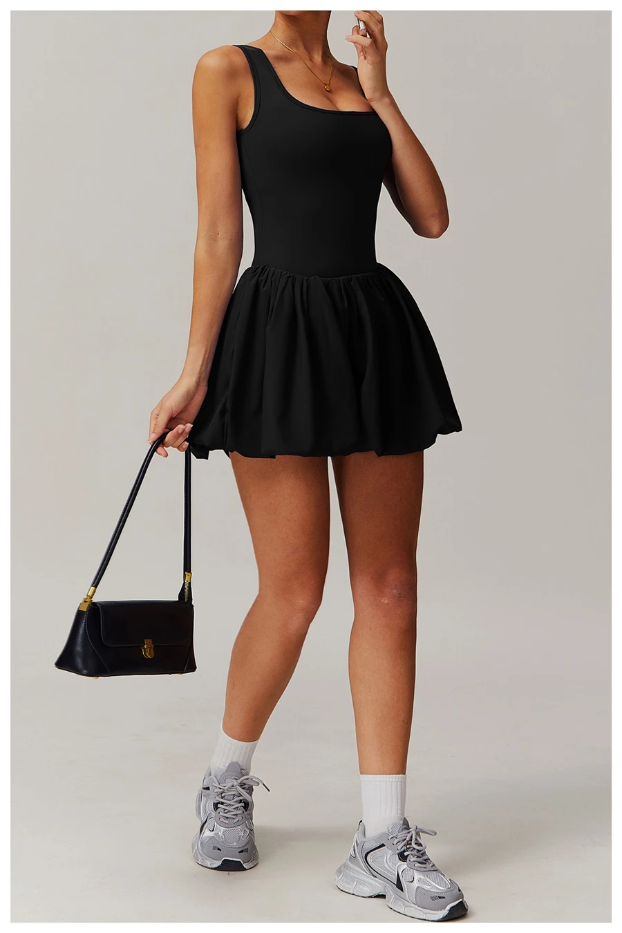 2-in-1 sports dress with built-in shorts for women in black, featuring flounce bubble hem and gathered waist