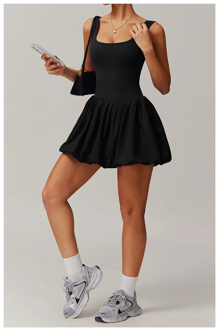 2-in-1 sports dress with built-in shorts for women in black, featuring flounce bubble hem and gathered waist