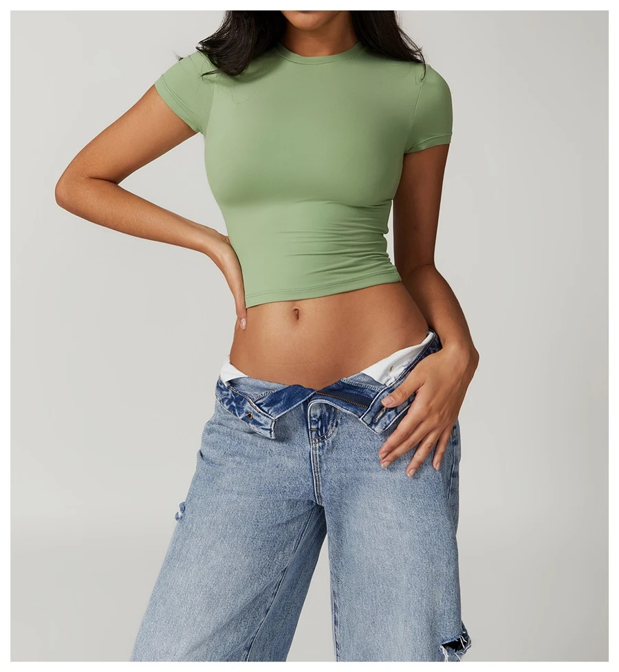 Women's cropped short sleeve yoga top in brushed four-way stretch fabric for yoga, Pilates, running, gym workouts, and activewear-green front view