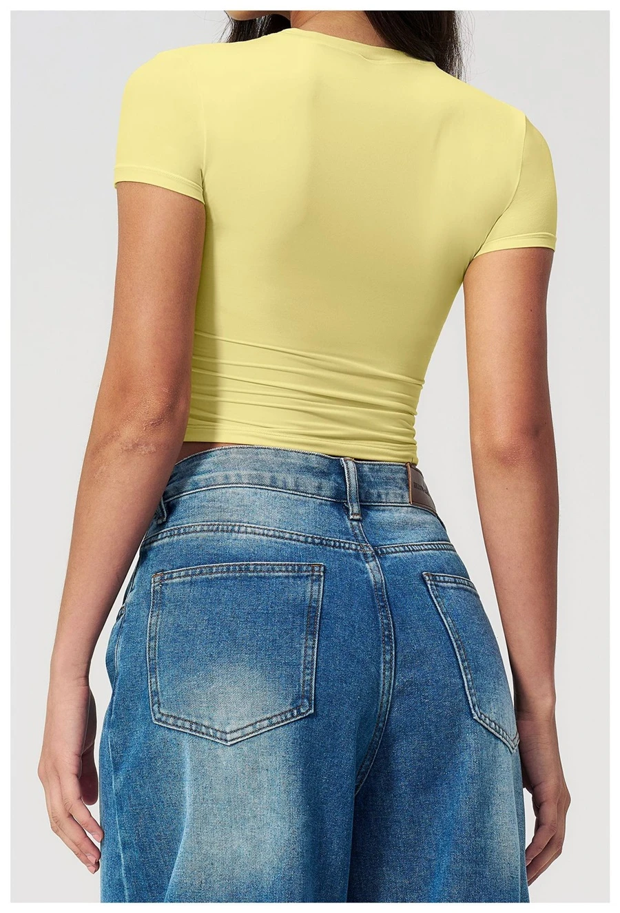 Women's cropped short sleeve yoga top in brushed four-way stretch fabric for yoga, Pilates, running, gym workouts, and activewear-lemon yellow back view