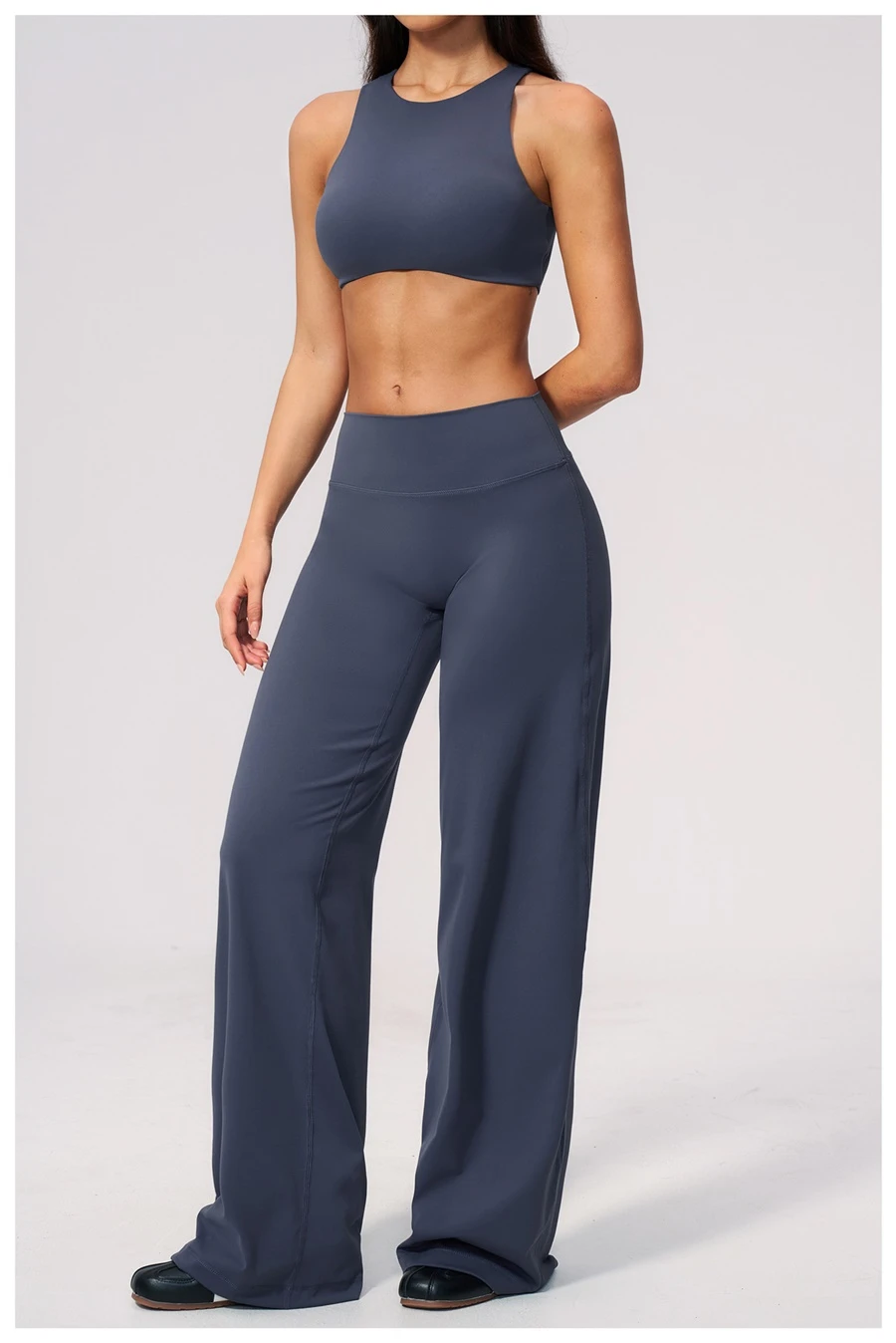 Woman wearing high impact backless sports bra during yoga and gym training-dark blue