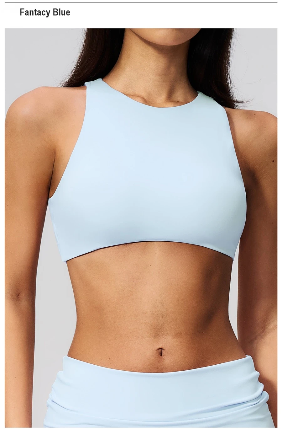 Woman wearing high impact backless sports bra during yoga and gym training-fantasy blue