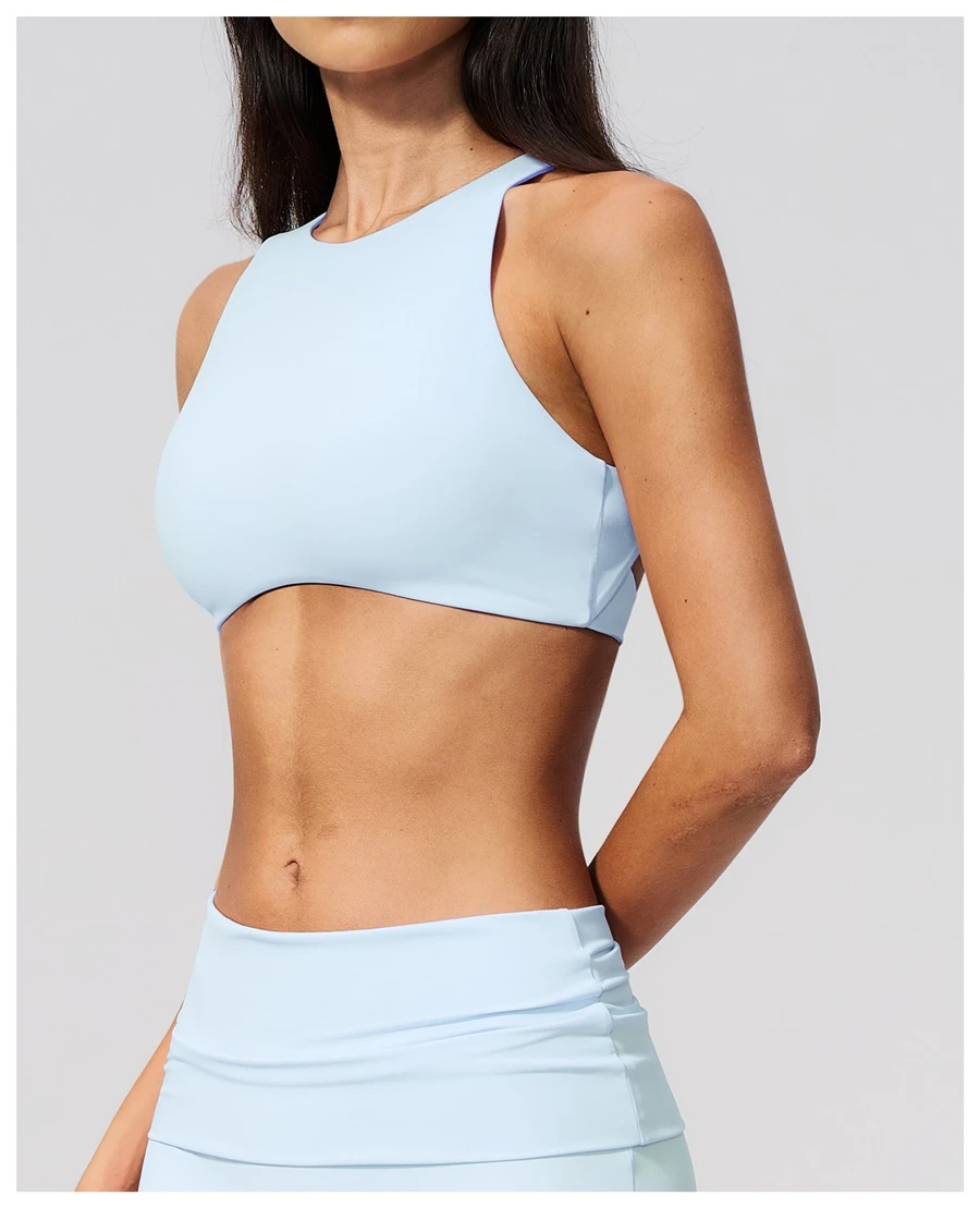 Woman wearing high impact backless sports bra during yoga and gym training-fantasy blue side view