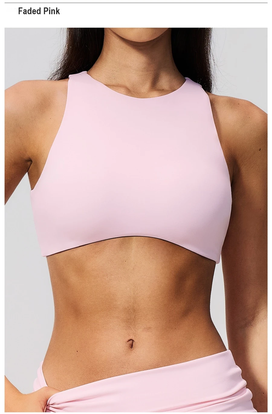 Woman wearing high impact backless sports bra during yoga and gym training-pink front