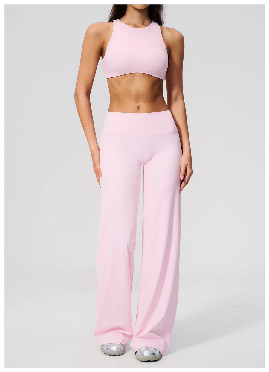 Woman wearing high impact backless sports bra during yoga and gym training-pink