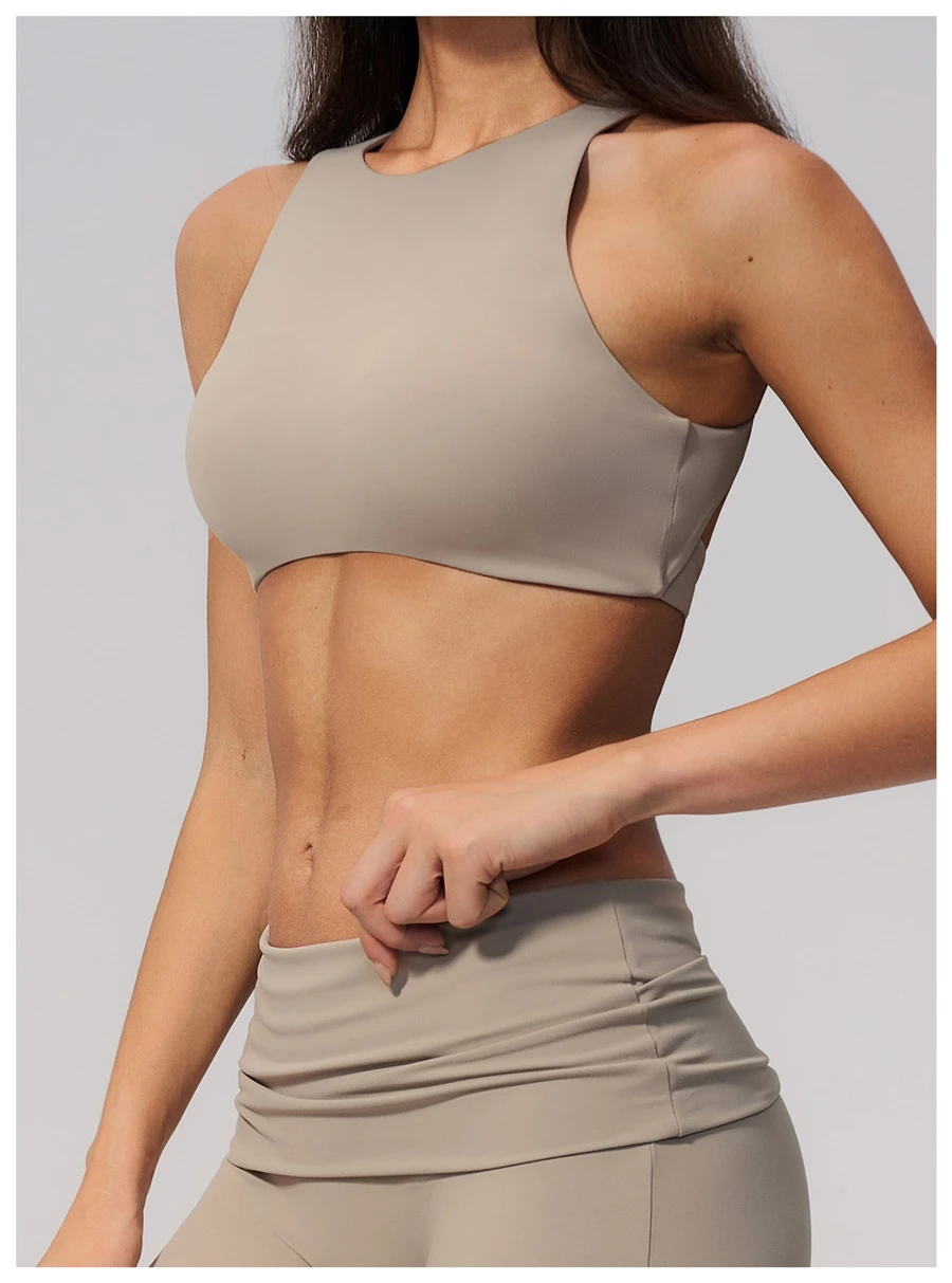 Woman wearing high impact backless sports bra during yoga and gym training-flaxen side view