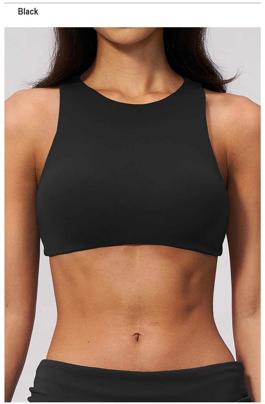 Woman wearing high impact backless sports bra during yoga and gym training-black front