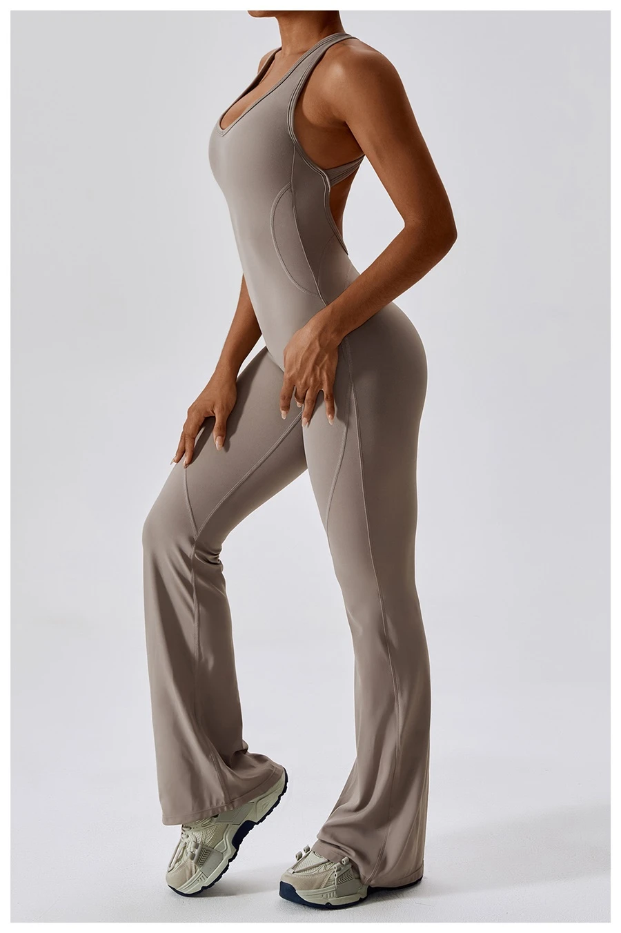 Side view of flare yoga jumpsuit highlighting tummy-control waist and leg-elongating flare silhouette