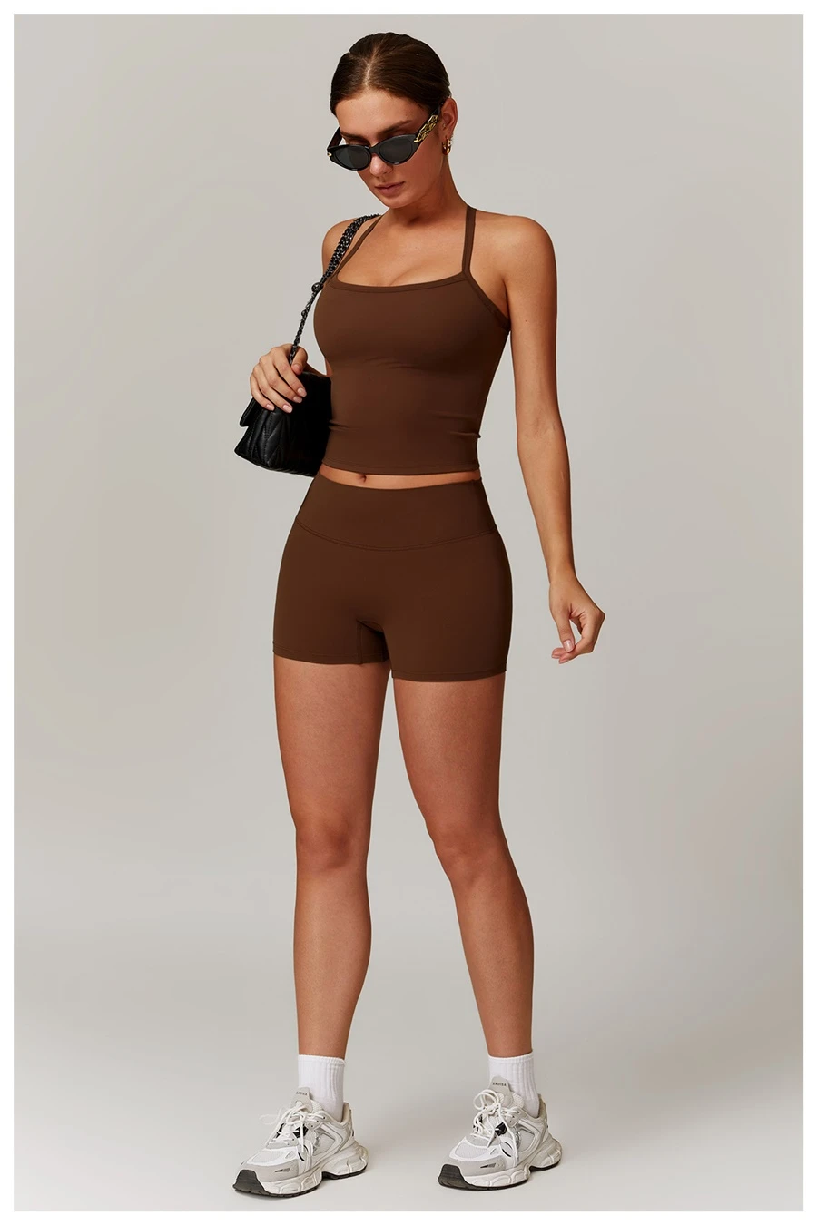 Women wearing matching yoga set for yoga running and gym training, slim fit style, cami top +shorts set chocolate