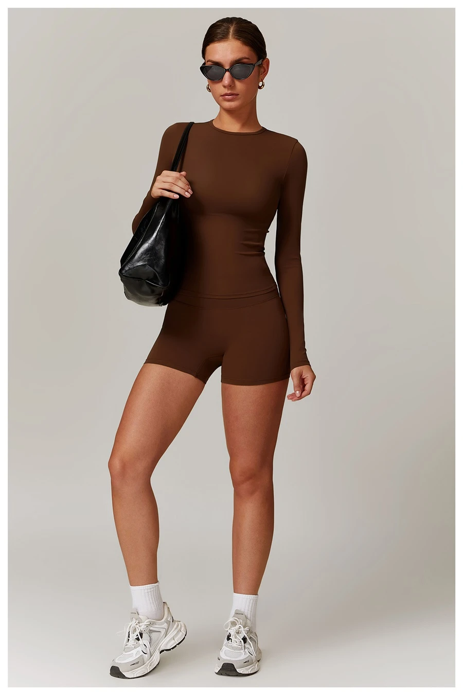 Women wearing matching yoga set for yoga running and gym training, slim fit style, long sleeve +shorts set chocolate
