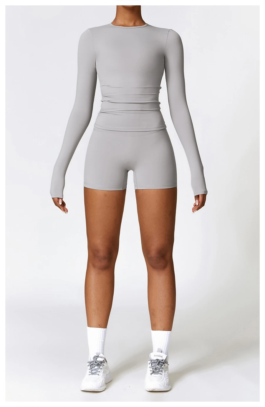 Women wearing matching yoga set for yoga running and gym training, slim fit style, long sleeve +shorts set gray