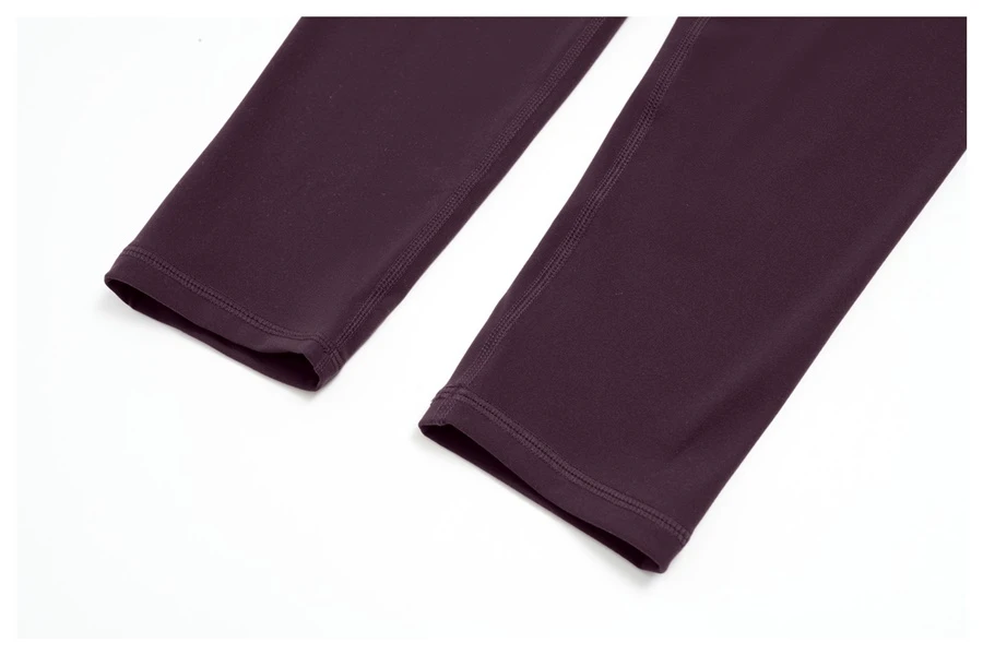 Women's seamless front workout leggings made from buttery soft nylon spandex fabric-hem