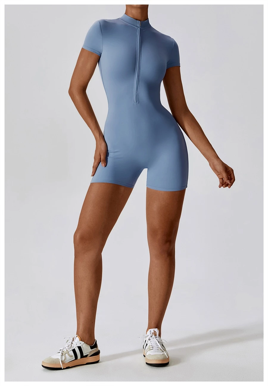 Short sleeve zip-up yoga bodysuit for women in black, featuring half-zip mock neck and waist-cinching silhouette