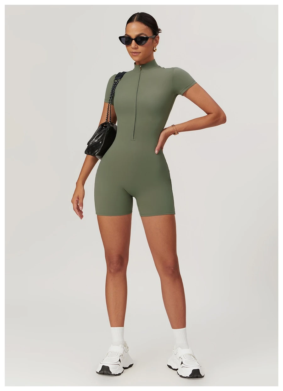 Woman wearing short sleeve zip-up bodysuit with high-waisted leggings – summer athleisure outfit