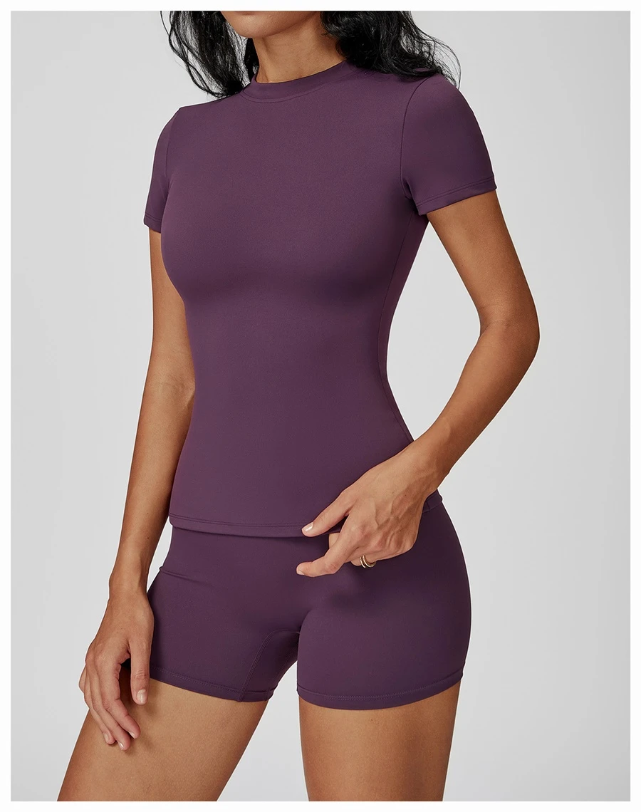 Women’s quick-dry yoga short sleeve tee in brushed nylon-spandex, slim-fit activewear top with classic crew neck and extended hem-deep purple side view