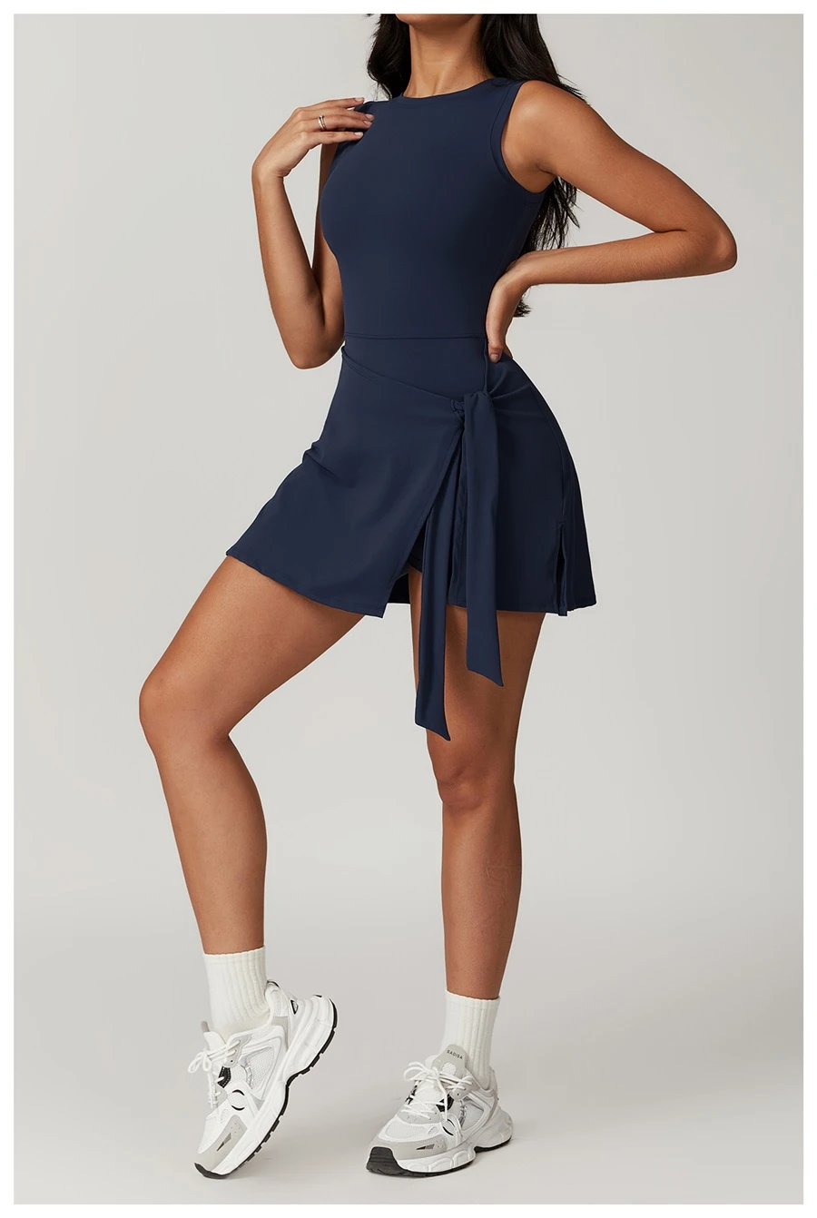 Side view of tennis dress highlighting adjustable cross-tie detail at the side slit
