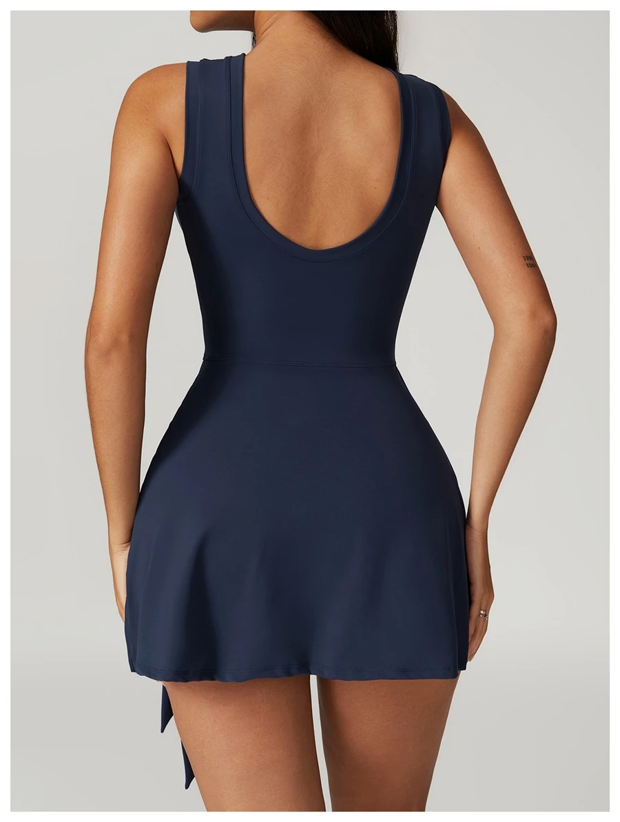 Back view of women's open back sports dress showcasing U-shaped cut-out and butterfly bone accentuation