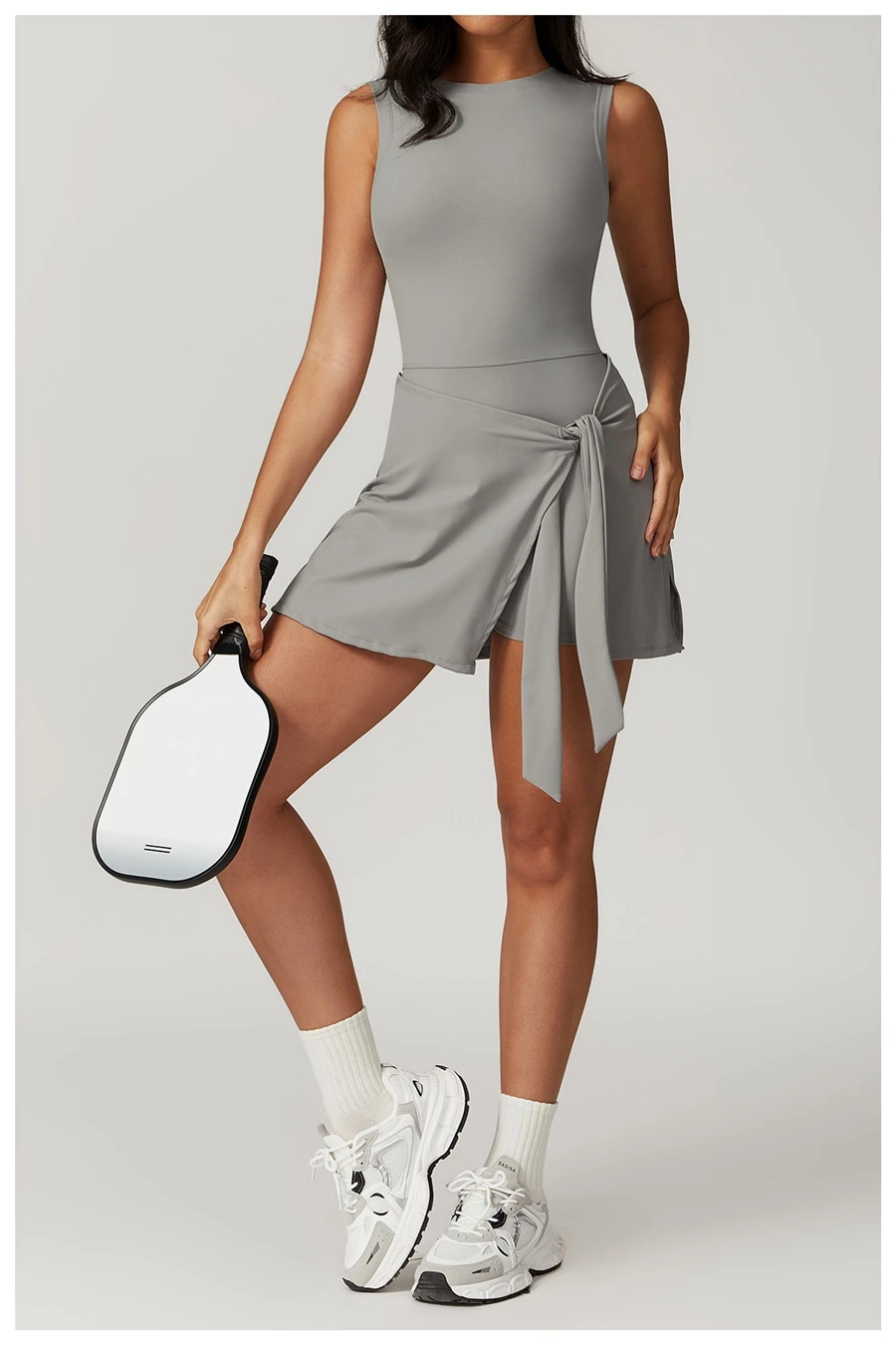 U back tennis dress for women in grey, featuring sleeveless neckline and A-line skirt silhouette