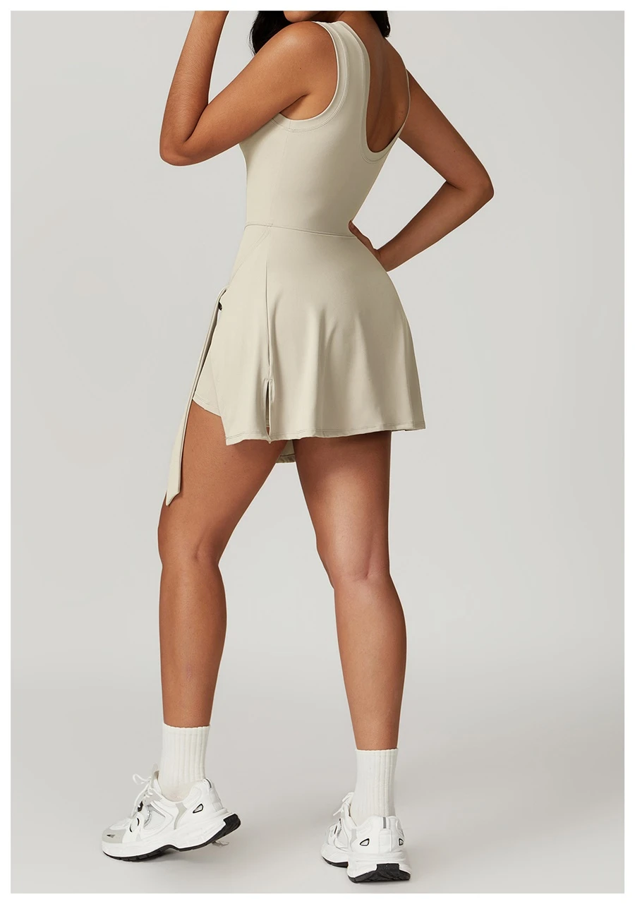 Back view of women's open back sports dress showcasing U-shaped cut-out and butterfly bone accentuation