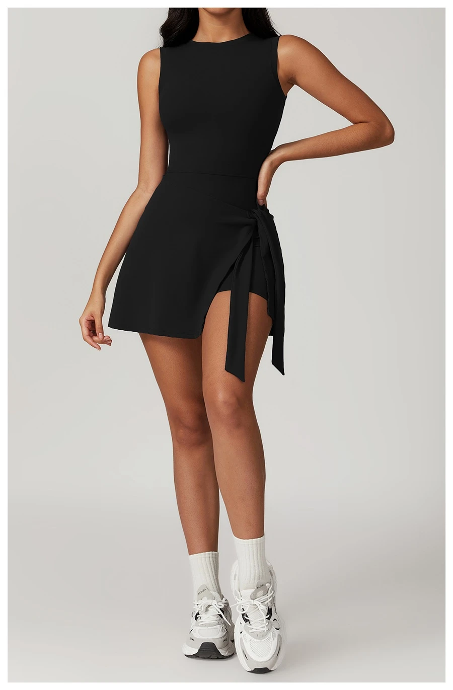 U back tennis dress for women in black, featuring sleeveless neckline and A-line skirt silhouette
