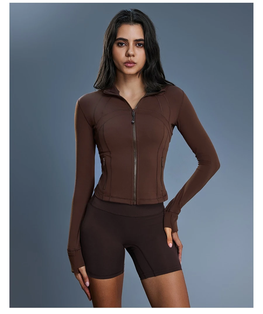 Women's zip up sports jacket with thumb hole cuffs and zipper pockets