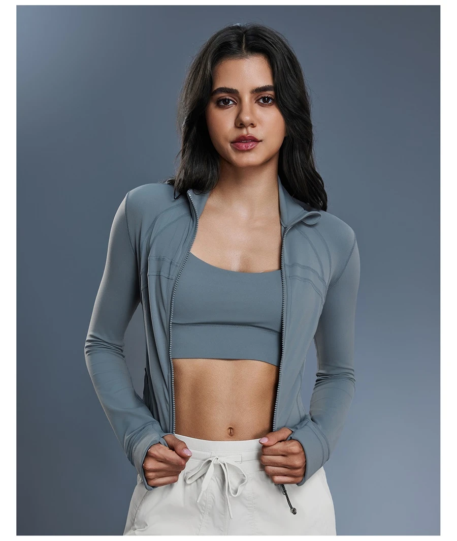 Women's zip up sports jacket with thumb hole cuffs and zipper pockets